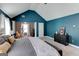 Spacious main bedroom with dark blue walls, exercise equipment, and a decorative ceiling fan at 4205 Lindsey Way, Conyers, GA 30013