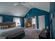 Spacious main bedroom with dark blue walls, exercise equipment, and a decorative ceiling fan at 4205 Lindsey Way, Conyers, GA 30013