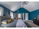 Spacious main bedroom with dark blue walls, exercise equipment, and a decorative ceiling fan at 4205 Lindsey Way, Conyers, GA 30013