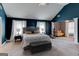 Spacious main bedroom with dark blue walls, exercise equipment, and a decorative ceiling fan at 4205 Lindsey Way, Conyers, GA 30013