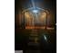 Nighttime view of covered patio featuring string lights and outdoor seating for relaxation and entertainment at 4205 Lindsey Way, Conyers, GA 30013