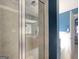 Modern tile walk-in shower featuring seamless glass doors, updated fixtures, and vanity in view at 4205 Lindsey Way, Conyers, GA 30013