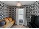 Cozy sitting area with yellow sofa, geometric wallpaper, natural light, and a modern aesthetic at 4205 Lindsey Way, Conyers, GA 30013