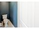 Toilet in bathroom with light tile floor and light blue wall at 4205 Lindsey Way, Conyers, GA 30013