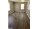 Bright living room features wood-look floors and a window for natural light at 3720 Asbury Sw Ln, Atlanta, GA 30331