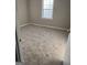 Cozy bedroom featuring neutral carpet, a bright window, and fresh paint at 30 Lemon Pl, Mcdonough, GA 30253