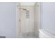 Tiled walk-in shower with a rain shower head and built-in shelving at 2511 Due West Nw Cir, Kennesaw, GA 30152