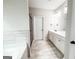 This bathroom features a double sink vanity with a glass enclosed shower and separate soaking tub at 9178 Lakeview Pkwy, Villa Rica, GA 30180