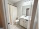 This bathroom has tile floors, a single sink vanity and a shower with curtain at 9178 Lakeview Pkwy, Villa Rica, GA 30180