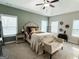 Tranquil bedroom with natural light, tray ceiling and a seating area at 9178 Lakeview Pkwy, Villa Rica, GA 30180