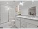 Well-lit bathroom with double sink vanity, walk-in shower, and marble countertops at 2271 Rolling Trl, Lithonia, GA 30058