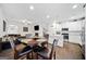Open-concept living space including a kitchen, living room, and breakfast nook with a round wooden table at 2271 Rolling Trl, Lithonia, GA 30058