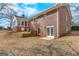 Brick home featuring a sunroom, a walkout basement, and a backyard at 210 Heritage Cir, Mcdonough, GA 30253