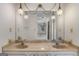 Bathroom vanity featuring a double sink and decorative lights at 210 Heritage Cir, Mcdonough, GA 30253