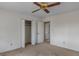 Bright bedroom featuring a ceiling fan, closet, and neutral carpet at 210 Heritage Cir, Mcdonough, GA 30253