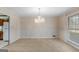 Dining room with stylish chandelier and a large window at 210 Heritage Cir, Mcdonough, GA 30253