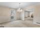 Elegant dining room with a stylish chandelier and large windows at 210 Heritage Cir, Mcdonough, GA 30253