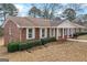 Attractive brick home boasting a classic design, manicured landscaping, and inviting front porch at 210 Heritage Cir, Mcdonough, GA 30253