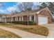 Charming brick home featuring manicured landscaping and a two-car garage at 210 Heritage Cir, Mcdonough, GA 30253