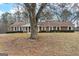 Lovely brick home showcasing large front yard, white trim, and well-maintained landscaping at 210 Heritage Cir, Mcdonough, GA 30253