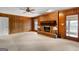 Living room features a brick fireplace, wood paneling, and a ceiling fan at 210 Heritage Cir, Mcdonough, GA 30253