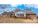 Brick home featuring a sunroom, a walkout basement, and a backyard at 210 Heritage Cir, Mcdonough, GA 30253