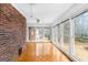 Sunroom featuring a brick wall, parquet floor, multiple windows and a ceiling fan at 210 Heritage Cir, Mcdonough, GA 30253