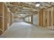 Spacious unfinished basement with exposed ceiling, framing, and concrete floor at 6025 Old Timber Trl # 11, Douglasville, GA 30135