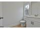 Bathroom featuring modern fixtures, a white vanity, and a window offering natural light at 6025 Old Timber Trl # 11, Douglasville, GA 30135