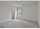 Clean, light-filled bedroom with neutral carpet, white walls, and a walk-in closet at 6025 Old Timber Trl # 11, Douglasville, GA 30135