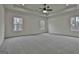 Large bedroom with trey ceiling, neutral carpet, and three windows offering ample natural light at 6025 Old Timber Trl # 11, Douglasville, GA 30135