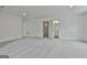 Large bonus room featuring neutral carpet, and access to the bathroom with white cabinets at 6025 Old Timber Trl # 11, Douglasville, GA 30135