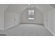 Bright bonus room with plush gray carpet and two windows offering natural light at 6025 Old Timber Trl # 11, Douglasville, GA 30135