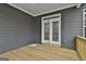 Wooden deck with gray siding and white trim, offering a view of the backyard area at 6025 Old Timber Trl # 11, Douglasville, GA 30135