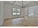 Spacious dining room featuring hardwood floors and a view to the front yard through a large window at 6025 Old Timber Trl # 11, Douglasville, GA 30135