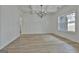 Open dining room showcasing modern lighting, coffered ceilings, and beautiful hardwood floors at 6025 Old Timber Trl # 11, Douglasville, GA 30135