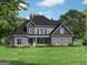Charming two-story home featuring stone accents, gray siding, and a well-manicured lawn at 6025 Old Timber Trl # 11, Douglasville, GA 30135