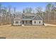 Beautiful exterior featuring a balanced combination of gray siding, stone accents, and a well-maintained lawn at 6025 Old Timber Trl # 11, Douglasville, GA 30135