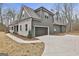 Side view of home, showcasing a two-car garage with convenient driveway access at 6025 Old Timber Trl # 11, Douglasville, GA 30135