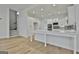Modern kitchen boasts white cabinetry, gray backsplash, stainless appliances, and large center island at 6025 Old Timber Trl # 11, Douglasville, GA 30135