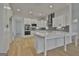 Open kitchen featuring white cabinets, stainless steel appliances, gray backsplash, and quartz countertop island at 6025 Old Timber Trl # 11, Douglasville, GA 30135