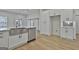 Modern kitchen features stainless steel appliances, white cabinets, and large island with countertop sink at 6025 Old Timber Trl # 11, Douglasville, GA 30135