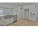 Bright, modern kitchen with stainless steel appliances, a large island sink, and abundant white cabinetry at 6025 Old Timber Trl # 11, Douglasville, GA 30135
