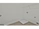 A bright laundry room includes washer/dryer hookups, tile flooring, and storage space at 6025 Old Timber Trl # 11, Douglasville, GA 30135