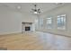 The living room boasts a stone fireplace, hardwood floors, and ample natural light at 6025 Old Timber Trl # 11, Douglasville, GA 30135