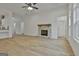 Cozy living room with a stone fireplace, hardwood floors, and large windows for natural light at 6025 Old Timber Trl # 11, Douglasville, GA 30135