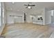 This open-concept space features sliding barn doors and an entrance to a modern kitchen at 6025 Old Timber Trl # 11, Douglasville, GA 30135