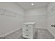 Walk-in closet featuring carpet, white walls, and a center island for ample storage at 6025 Old Timber Trl # 11, Douglasville, GA 30135