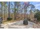Paver stone patio in wooded backyard has ample seating and a peaceful, private feel at 6142 Golf View Xing, Locust Grove, GA 30248