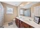 Bathroom features a double vanity with a large mirror and a shower with a striped curtain at 6142 Golf View Xing, Locust Grove, GA 30248